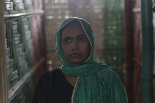Nur Halima, 35, poses for a portrait inside a CARE-provided women-friendly space, in Potibunia Camp, Bangladesh, on May 18, 2018. She and her family of seven hid for 10 days in a forest before they were able to escape. (Aungmakhai Chak/DEC)