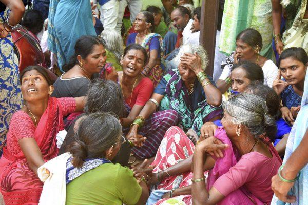 Relatives of victims of a bus accident wail near a hospital in Jagtiyal district of Telangana, India, on Sept. 11, 2018. A bus carrying pilgrims from a Hindu temple in the hills of south India plunged off a road Tuesday, killing more than 50 people including four children, officials said. (AP Photo)