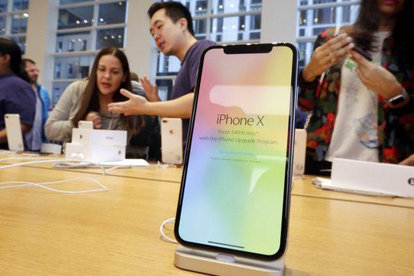 Customers buy the iPhone X at the Apple Store on New York's Fifth Avenue on Nov. 3, 2017. Apple is expected to unveil its biggest and most expensive iPhone on Wednesday, Sept. 12, 2018, as part of a lineup of three new models aimed at widening the product’s appeal amid slowing sales growth. (Richard Drew/AP)