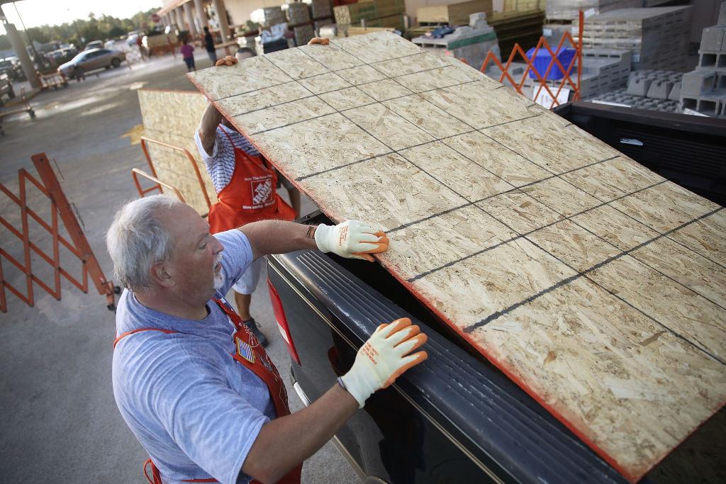 Home Depot employee Jim Brown helps a customer load plywood into his truck as residents prepare for the arrival of Hurricane Florence in Myrtle Beach, South Carolina, on Sept. 11, 2018.
