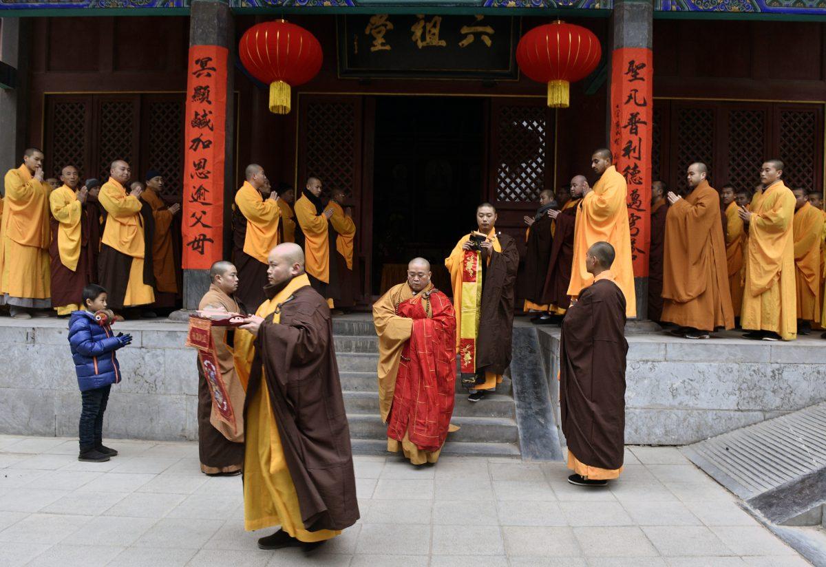 In this photo taken on Jan. 28, 2017, Chinese monks attend a ceremony at Shaolin Temple in Dengfeng, Henan Province, China, on Jan. 28, 2017. In an unprecedented move, the Chinese regime has required the temple to display a national flag in a show of loyalty to the Chinese Communist Party. (STR/AFP/Getty Images)