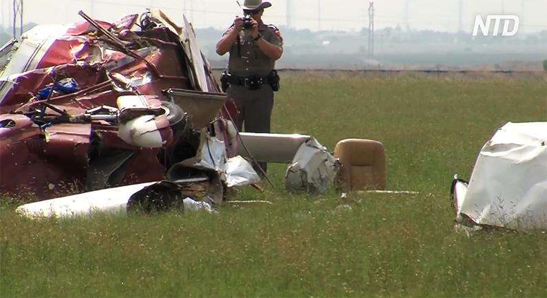 nvestigators examine the wreckage of the crashed Piper 32. (Screenshot/NTD)