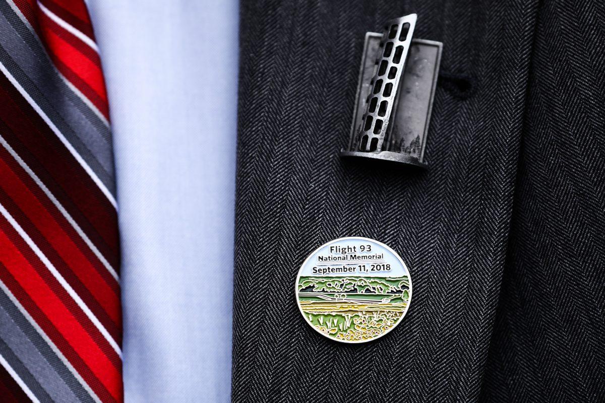 Pins on the jacket of an attendee at the Flight 93 September 11 Memorial Service in Shanksville, Pa., on Sept. 11, 2018. (Samira Bouaou/The Epoch Times)
