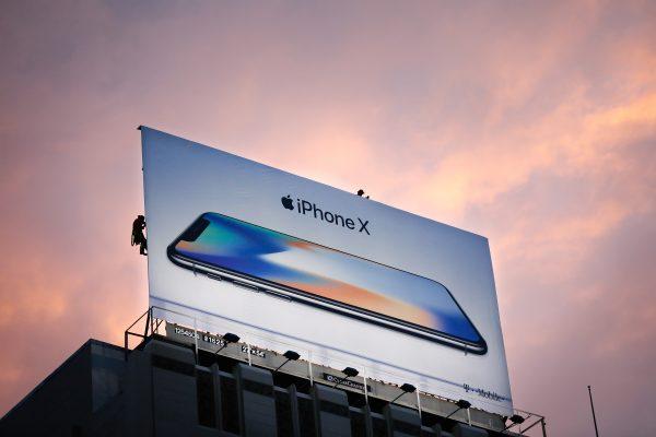 Workers finish putting up a new iPhone X billboard above Union Square in advance of the iPhone X launch on Nov. 3, 2017, in San Francisco, Calif. (Photo by Elijah Nouvelage/AFP/Getty Images)