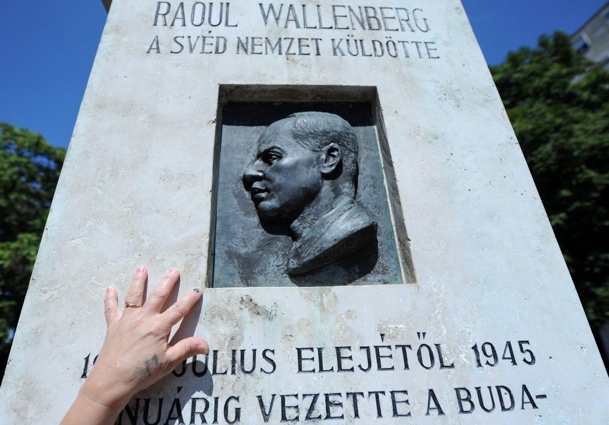 A Hungarian woman touches the memorial stone of late Swedish diplomat Raoul Wallenberg in St. Istvan park in Budapest on Aug. 1, 2012, just prior to the 100th anniversary of Wallenberg's birthday. Wallenberg, known for rescuing tens of thousands of Hungarian Jews from the Holocaust, disappeared without a trace after the Soviet occupation of Budapest in 1945. (ATTILA KISBENEDEK/AFP/GettyImages)