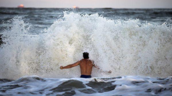 Body surfer Andrew Vanotteren crashes into waves from Hurricane Florence on the south beach of Tybee Island, Georgia on Wednesday, Sept. 12, 2018. (AP Photo/Stephen B. Morton)