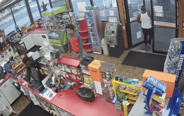 Two teenagers rob a store and another man walks away while a store clerk lies unconscious on the floor in Auburn, Wash. on Sept. 8, 2018. (Screenshot/Auburn Police Department)