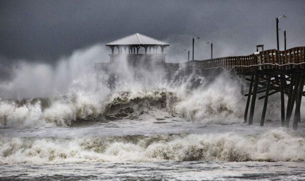 Waves slam the Oceana Pier & Pier House Restaurant in Atlantic Beach, N.C., Sept. 13, 2018 as Hurricane Florence approaches the area. (Travis Long /The News & Observer via AP)