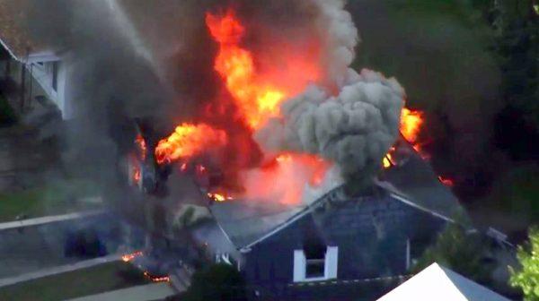In this image take from video provided by WCVB in Boston, flames consume a home in Lawrence, Mass, a suburb of Boston, on Sept. 13, 2018. (WCVB via AP)
