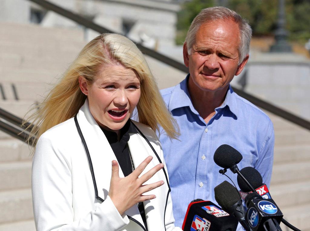 Elizabeth Smart speaks during a news conference while her father Ed Smart looks on Sept. 13, 2018, in Salt Lake City. Smart says it appears there is no viable, legal recourse she can take to stop the release of one of her kidnappers. Smart said at a news conference Thursday in Salt Lake City that she only found out about 72-year-old Wanda Barzee's release shortly before the public did. (AP Photo/Rick Bowmer)