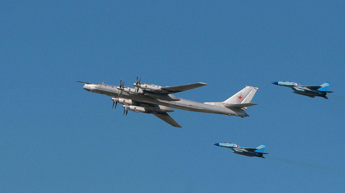 A Russian strategic bomber Tu-95 surrounded by MiG-29s, in this file photo. (AFP/Getty Images)