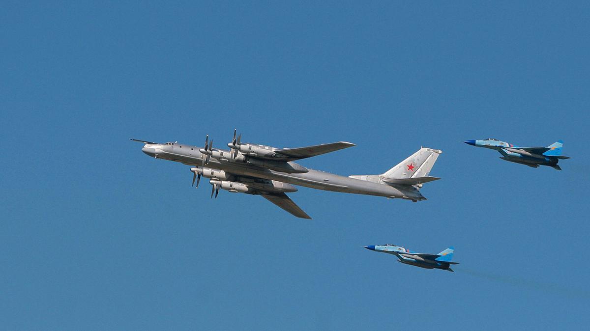 Russian strategic bomber TU-95 surrounded by MiG-29s flies over Monino Airfield, some 24 miles from Moscow, on Aug. 11, 2007. (AFP/Getty Images)