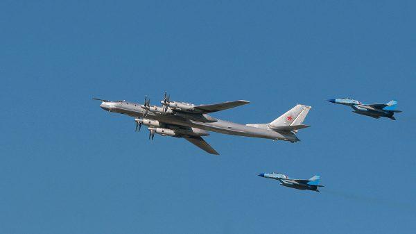Russian strategic bomber TU-95 surrounded by MiG-29 flies over Monino airfield, some 40 miles from Moscow, in August 2007. (AFP/Getty Images)