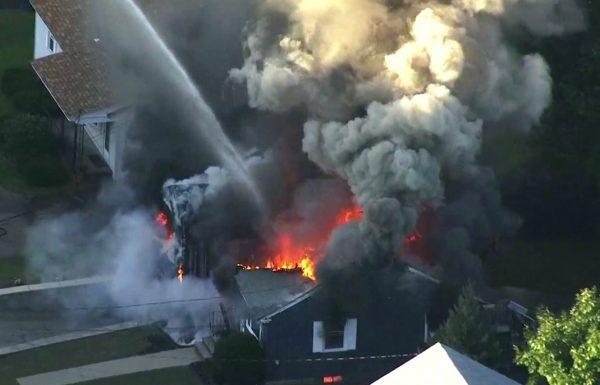 Flames consume the roof of a home in Lawrence, Mass, a suburb of Boston, on Sept. 13, 2018. (WCVB via AP)