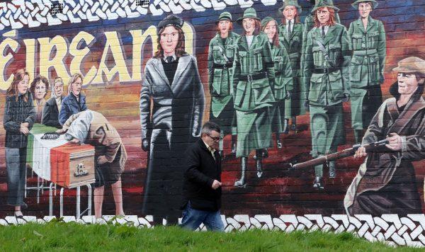 A man walks past a Republican mural in the Bogside neighborhood of Derry in Northern Ireland, on March 21, 2017. (Paul Faith/AFP/Getty Images)