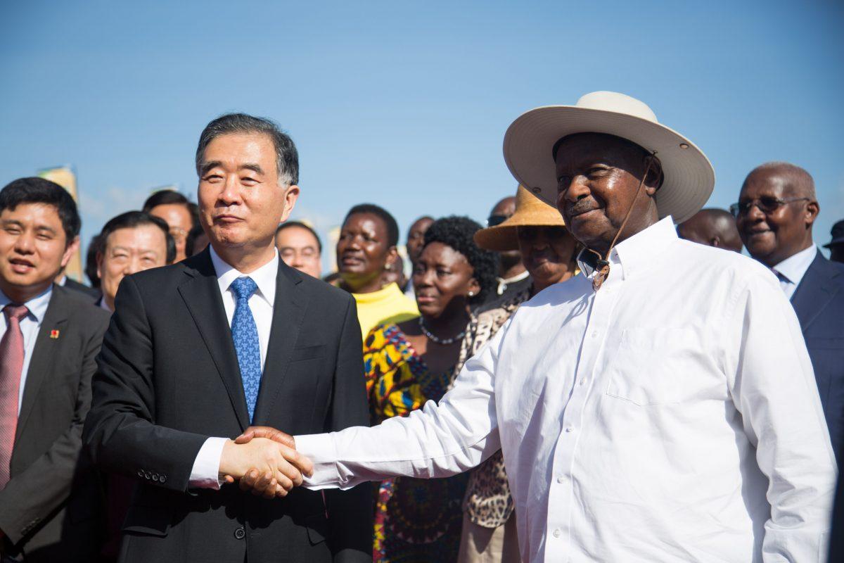 China's Vice Prime Minister Wang Yang and Uganda's President Yoweri Museveni shake hands as they pose during the inauguration ceremony of the Chinese-funded 51-kilometer Expressway linking the capital city and the international airport in Entebbe, Uganda, on June 15, 2018. (Sumy Sadurni/AFP/Getty Images)