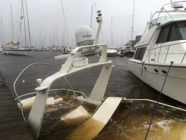 The mast of a sunken boat sits at a dock at the Grand View Marina in New Bern, N.C., on Friday, Sept. 14, 2018. Winds and rains from Hurricane Florence caused the Neuse River to swell, swamping the coastal city. (AP Photo/Allen G. Breed)