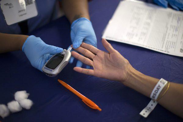 A person receives a test for diabetes during Care Harbor LA free medical clinic in Los Angeles, Calif., on Sept. 11, 2014. (Mario Anzuoni/Reuters)