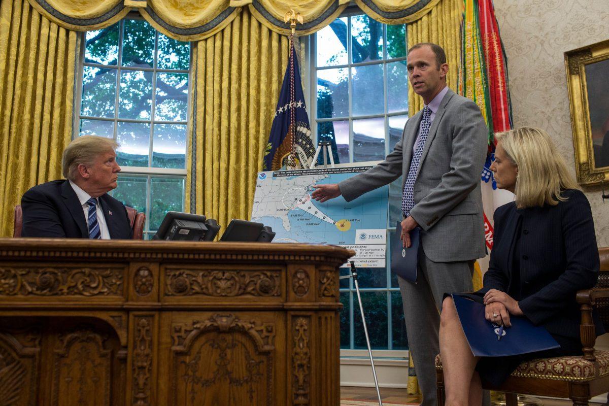 FEMA Administrator Brock Long (C) speaks to members of the press as President Donald Trump and Homeland Security Kirstjen Nielsen listen on in the Oval Office of the White House on Sept. 11, 2018. (Zach Gibson/AFP/Getty Images)