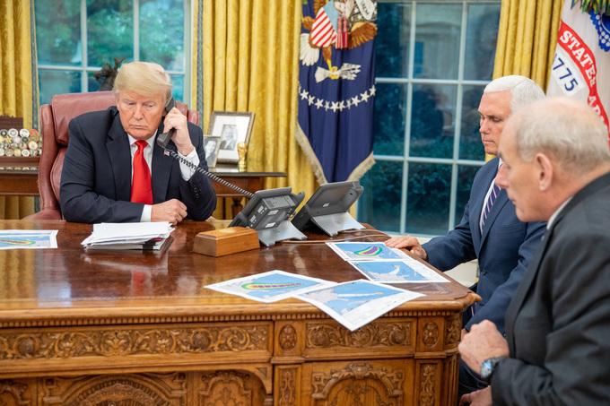 President Donald Trump talks via teleconference with FEMA officials regarding Hurricane Florence in the Oval Office of the White House in Washington on Sept. 10, 2018. Listening in are Vice President Mike Pence (C) and Chief of Staff Gen. John Kelly. (Official White House photo by Shealah Craighead)