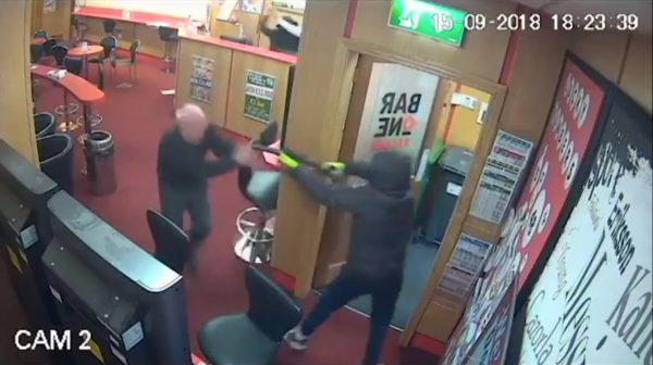 CCTV footage captures the moment that Denis O'Connor, 83, tackles a robber as he leaves the Bar One book keeper store in Cork, Ireland, on Sept. 15, 2018. (Bar One Racing via Storyful)