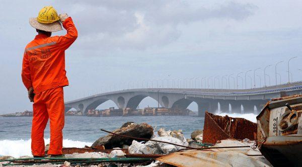 A construction worker looks on as the China-funded Sinamale bridge is seen in Male, Maldives, on Sept. 18, 2018. (Ashwa Faheem/Reuters)