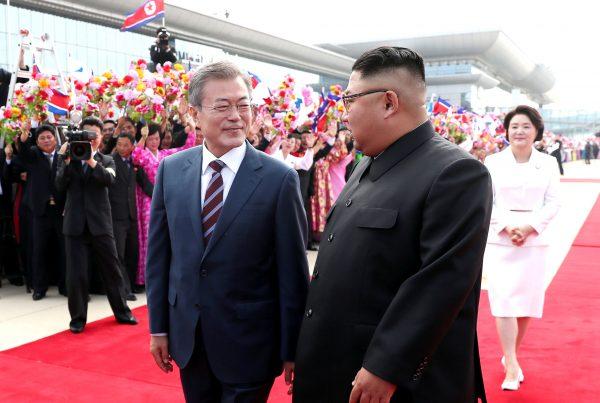 South Korean President Moon Jae-in and North Korean leader Kim Jong Un attend an official welcome ceremony at Pyongyang Sunan International Airport, in Pyongyang, North Korea, on Sept. 18, 2018. (Pyeongyang Press Corps/Pool via Reuters)