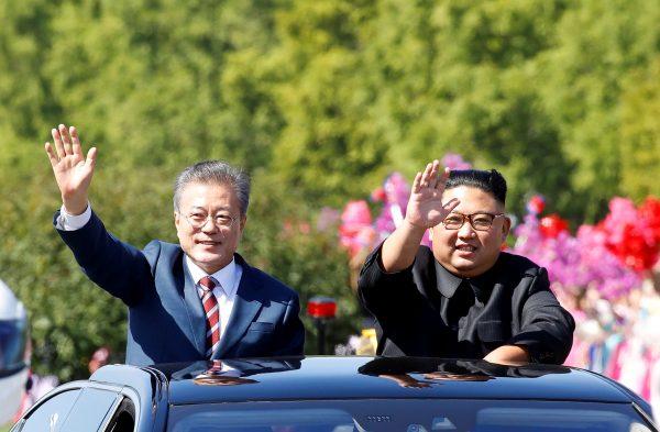 South Korean President Moon Jae-in and North Korean leader Kim Jong Un wave during a car parade in Pyongyang, North Korea, on Sept. 18, 2018. (Pyeongyang Press Corps/Pool via Reuters)