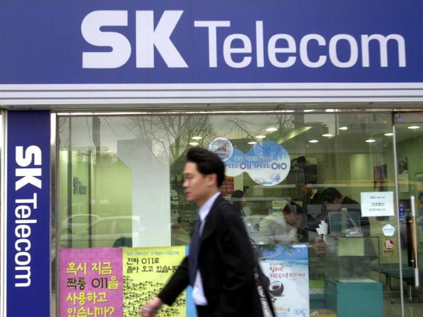 A South Korean walks past a SK Telecom shop in Seoul on Feb. 24, 2004. (Jung Yeon-Je/AFP/Getty Images)