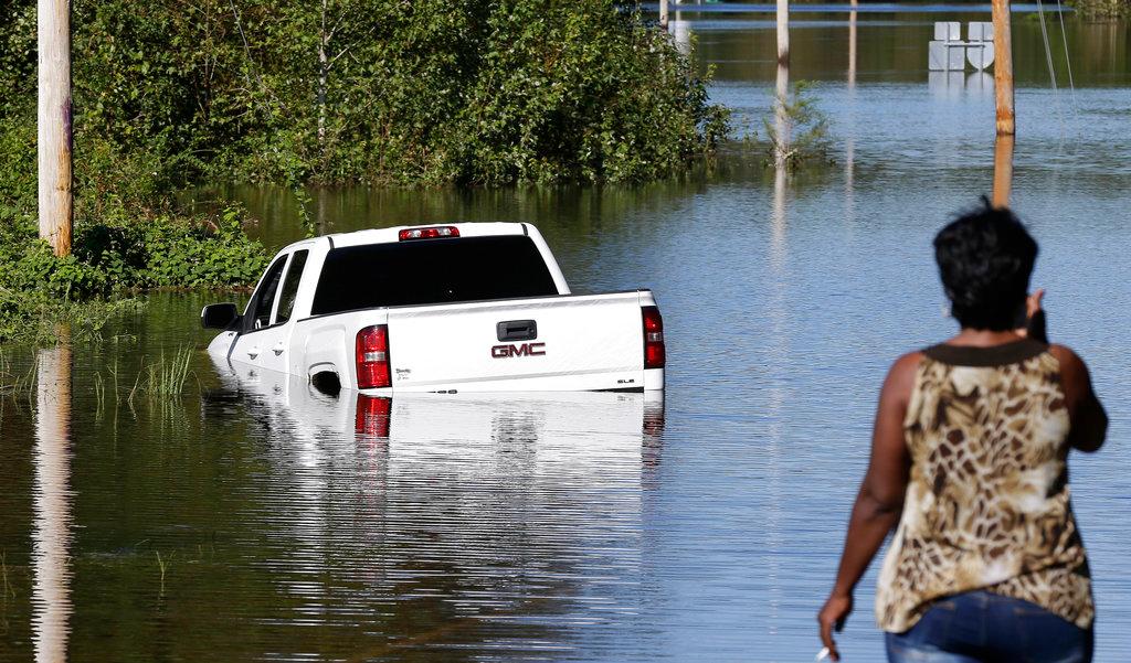 A resident surveys a road inundated by water in Lumberton, N.C., on Sept. 18, 2018, following flooding from Hurricane Florence. (AP Photo/Gerry Broome)