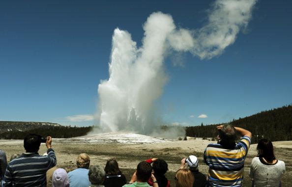 Tourists watch the 'Old Faithful' geyser which erupts on average every 90 minutes in the Yellowstone National Park, Wyoming, on June 1, 2011. (Mark Ralston/AFP/Getty Images)