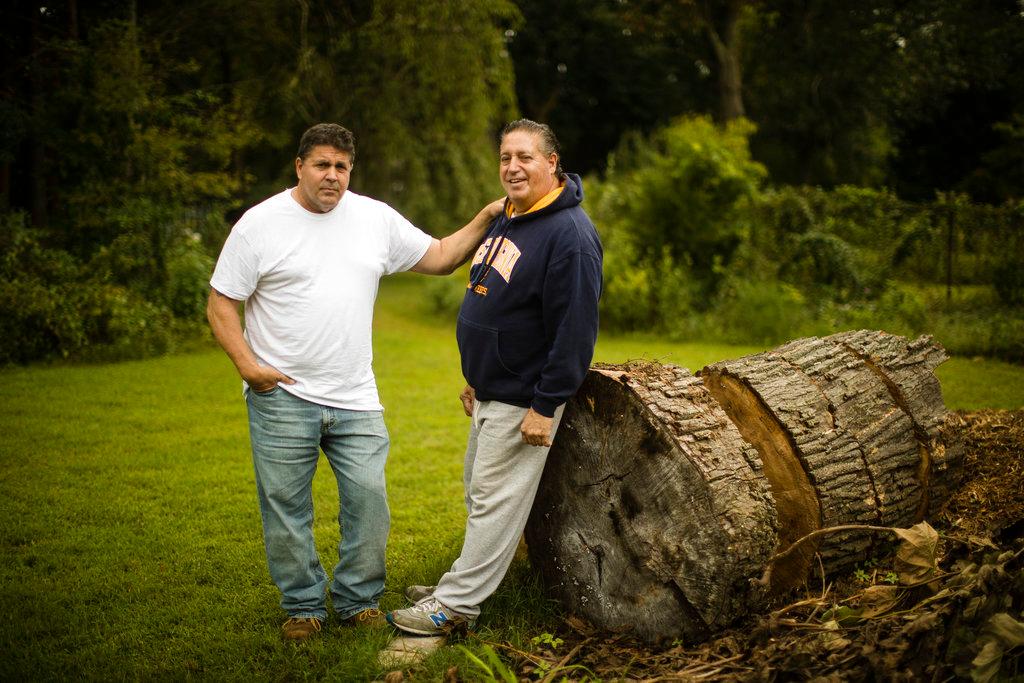Anthony Torres, right, poses for a photograph with his brother Tom Torres, in Atco, N.J., Sept. 17, 2018. (AP Photo/Matt Rourke)