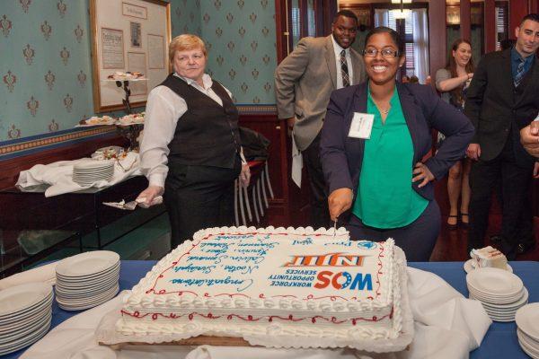 Shaliyah Ali cutting the cake at the Workforce Opportunity Services graduation. (Courtesy of Workforce Opportunity Services)