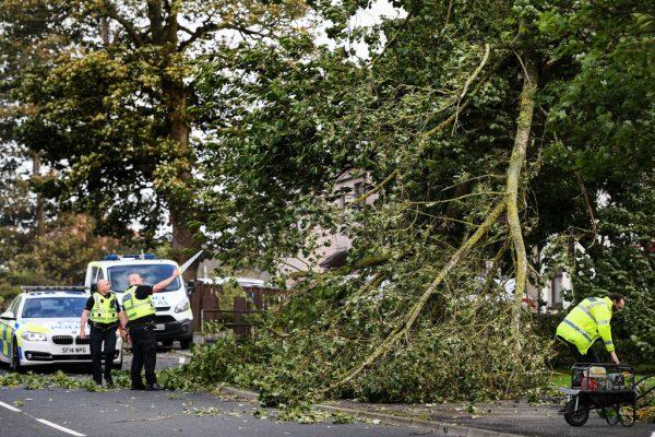Police clear a tree as Storm Ali hits land on Sept. 19, 2018 in Ardrossan, Scotland. (Jeff J Mitchell/Getty Images)