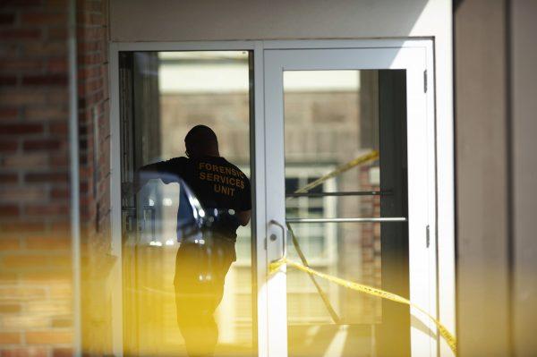 An officer investigates a shooting that occurred in the Masontown borough municipal center in Masontown, Pa. on Sept. 19, 2018. (Andrew Stein/Post-Gazette/AP)