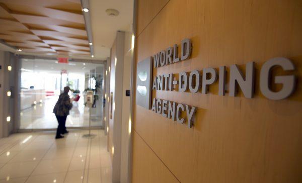 A woman walks into the head office for the World Anti-Doping Agency (WADA) in Montreal, Quebec, Canada, on Nov. 9, 2015. (Christinne Muschi/Reuters)
