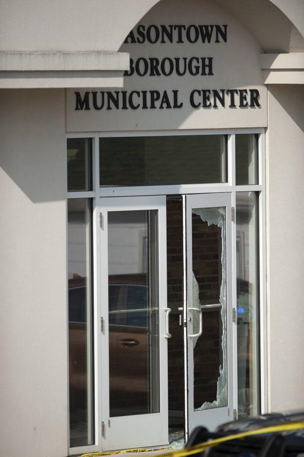 The glass is shattered on the door of the Masontown borough municipal center where a shooting occurred in Masontown, Pa. on Sept. 19, 2018. (Andrew Stein/Pittsburgh Post-Gazette/AP)