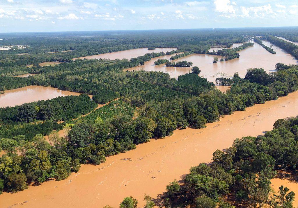 Rising flood waters in the Pee Dee area in Marion County, S.C., seen on Sept. 17, 2018. Two female mental health patients detained for medical transport drowned Tuesday, Sept. 18, when a sheriff's department van was swept away in rising floodwaters, according to authorities. (AP Photo/Meg Kinnard)