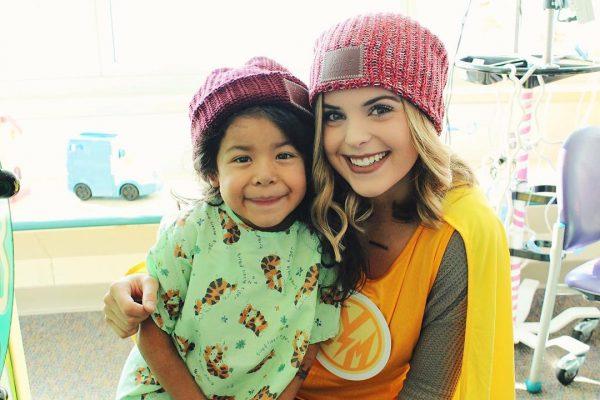 Love Your Melon volunteers, known as the “supercrew,” deliver beanies to children fighting pediatric cancer while they are in the hospital for treatment. (Courtesy of Love Your Melon)