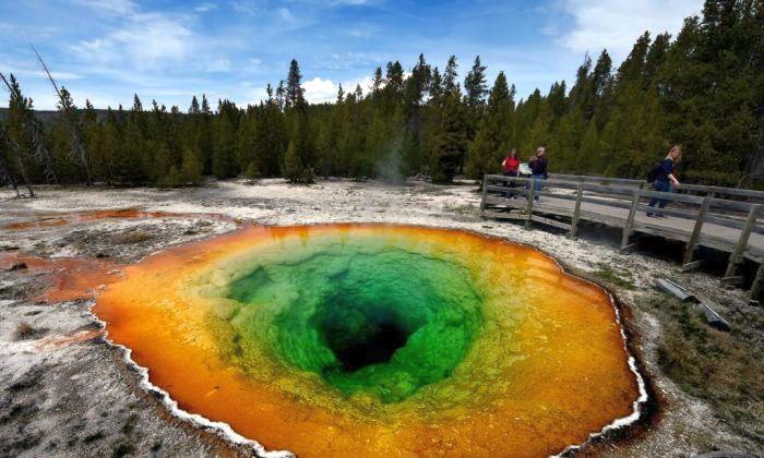 Tourists view the Morning Glory hot spring in the Upper Geyser Basin of Yellowstone National Park in Wyoming, on May 14, 2016. (Mark Ralston/AFP/Getty Images)