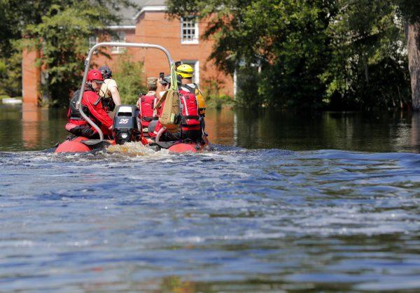 A swift recuse boat motors through floodwaters in the aftermath of Hurricane Florence in Nichols, S.C., on Sept. 21, 2018. Virtually the entire town is flooded and inaccessible except by boat, just two years after it was flooded by Hurricane Matthew. (AP Photo/Gerald Herbert)