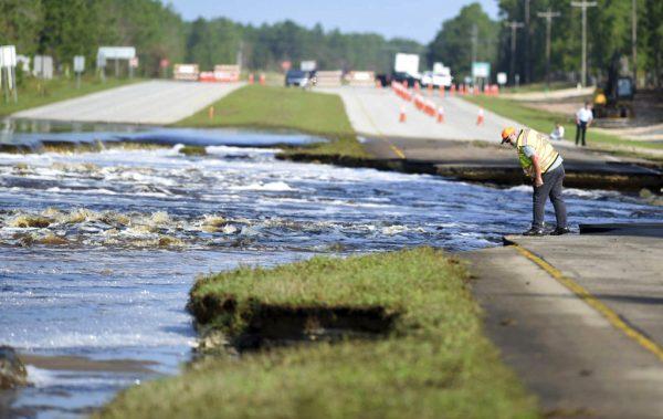 Flooding from Sutton Lake has washed away part of U.S. 421 in New Hanover County just south of the Pender County line in Wilmington, N.C., on Sept. 21, 2018. (Matt Born /The Star-News via AP)