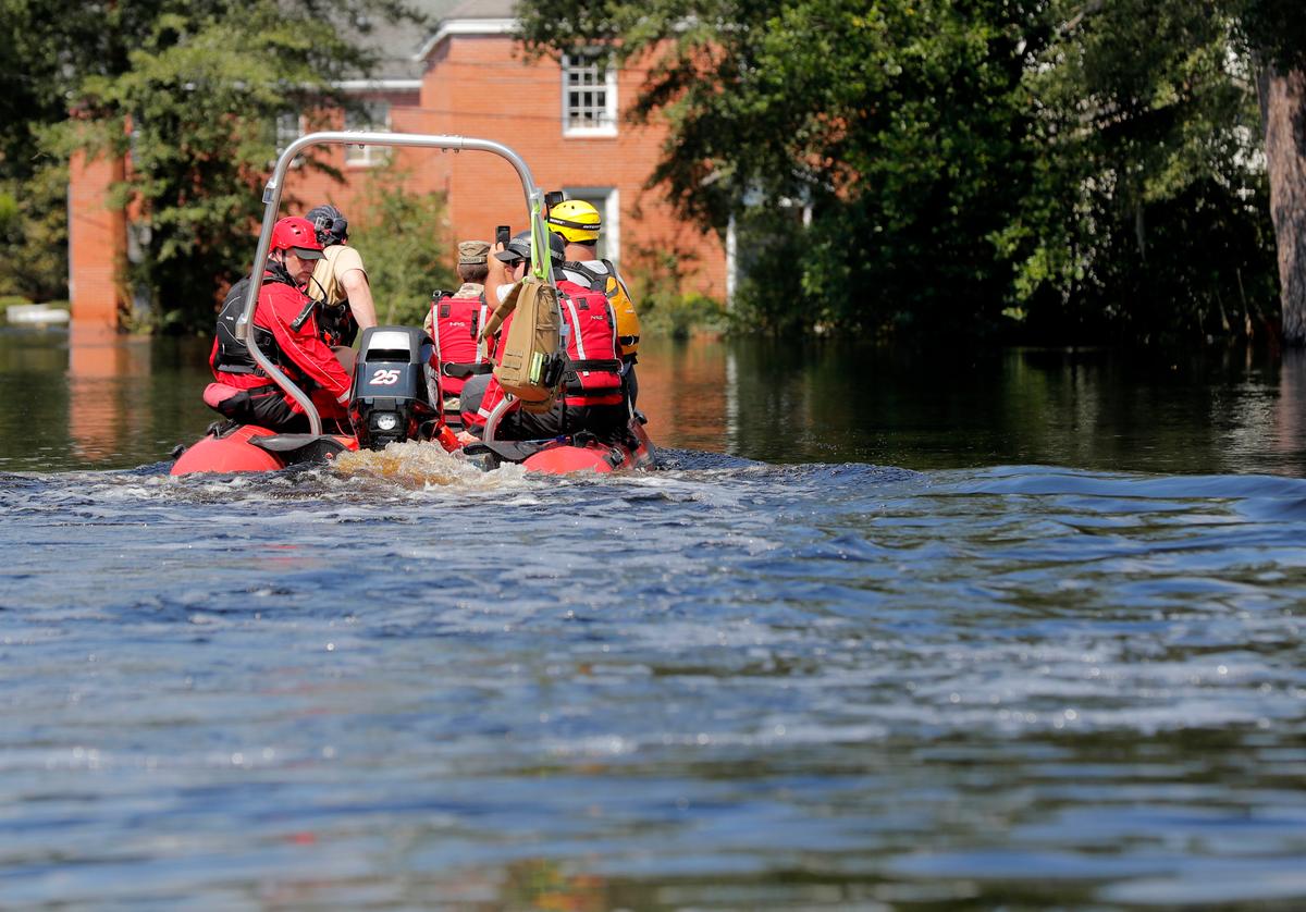 A swift recuse boat motors through floodwaters in the aftermath of Hurricane Florence in Nichols, S.C., Sept. 21, 2018. Virtually the entire town is flooded and inaccessible except by boat, just two years after it was flooded by Hurricane Matthew. (AP Photo/Gerald Herbert)