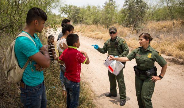 Border Patrol Agents talk to unaccompanied minors and others who just crossed the border illegally into the United States, in Hidalgo County, Texas, on May 26, 2017. (Benjamin Chasteen/The Epoch Times)