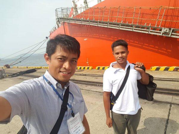 Aldi Novel Adilang (R), 19, poses with an Indonesian consular official upon landing in Japan after being stranded for 49 days in Guam waters. (KJRI Osaka/Facebook)