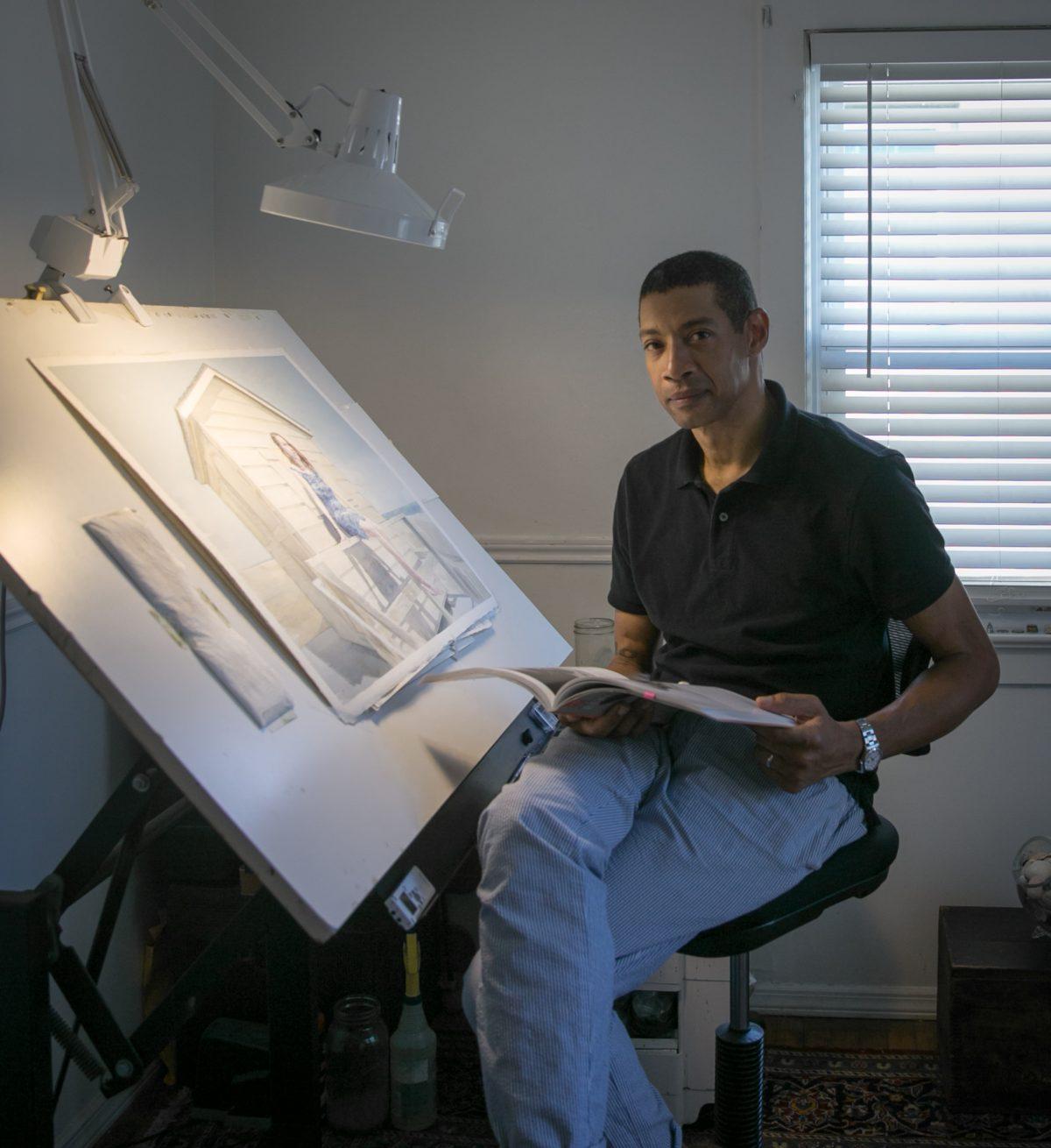 Mario A. Robinson shows his paintings, drawings, and book in his studio at home in Point Pleasant, New Jersey, on Sept. 4, 2018. (Milene Fernandez/The Epoch Times)