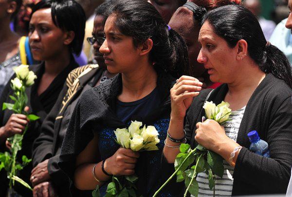 Relatives of victims of the Westgate shopping mall attack in Nairobi, Kenya, carry flowers during a ceremony marking the first anniversary of the attack, outside the Westgate Mall on Sept. 21, 2014. (Simon Maina/AFP/Getty Images)