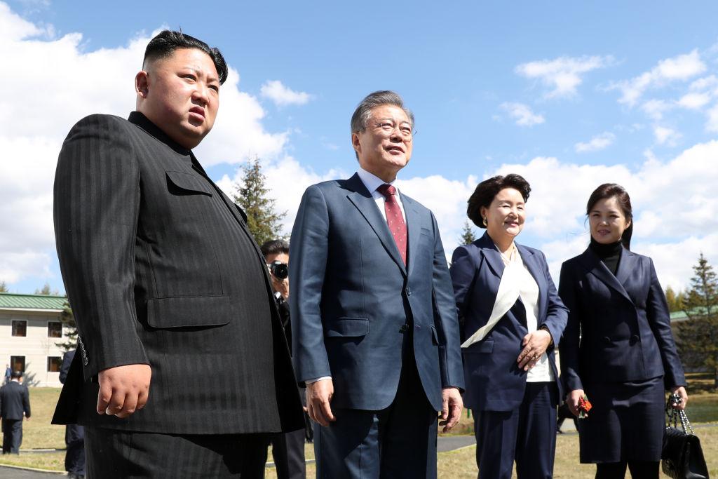 North Korea's leader Kim Jong Un (L) and his wife Ri Sol Ju (R) with South Korean President Moon Jae-in (2nd L) and his wife Kim Jung-sook (2nd R) during a visit to Samjiyon guesthouse in Samjiyon, North Korea, on Sept. 20, 2018. (Pyeongyang Press Corps/Pool/Getty Images)
