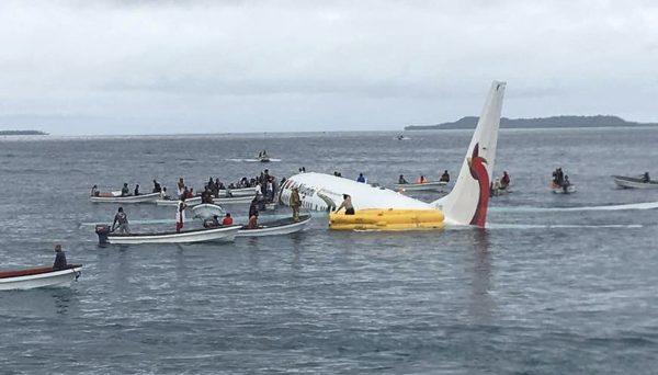 Local fishing boats move in to recover the passengers and crew of Air Niugini flight following the plane crashing into the sea on its approach to Chuuk International Airport in the Federated States of Micronesia, on Sept. 28, 2018. (James Yaingeluo/AP)