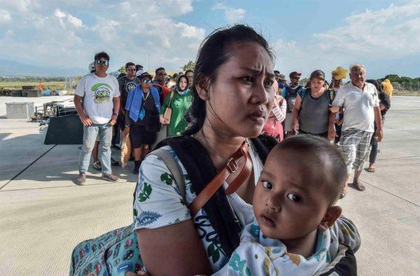 People injured or affected by the earthquake and tsunami wait to be evacuated on an air force plane in Palu, Central Sulawesi, Indonesia, Sept. 30, 2018. (Antara Foto/Muhammad Adimaja via Reuters)